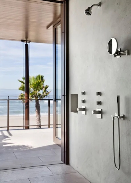 Minimalist Shower with Ocean View, Plaster Walls & Brushed Metal Fixtures