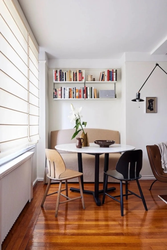 Minimalist Studio Dining Nook with Wall Mounted Bookshelves