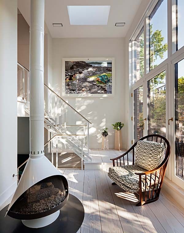 Minimalist White Cone Fireplace In Bright Airy Landing With Skylight