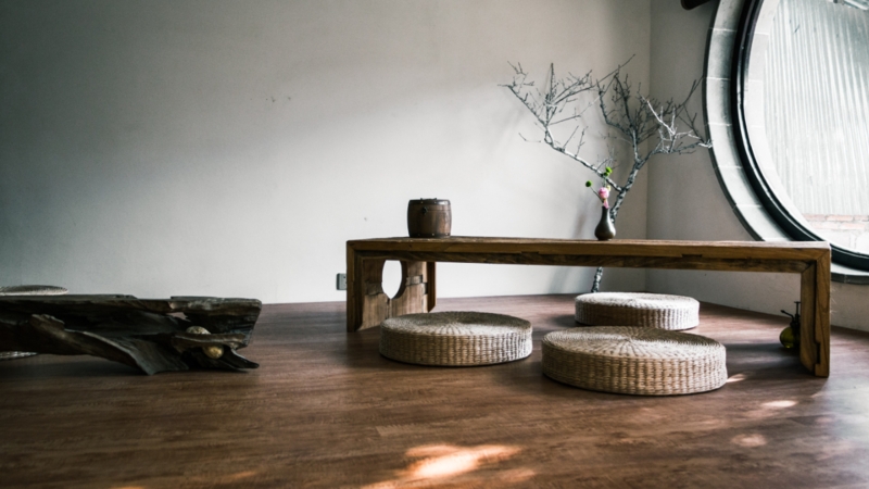 Minimalist Zen Lounge with Low Rustic Bench and Circular Window