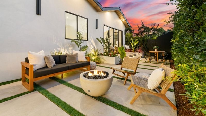 Modern Backyard Patio with Fire Pit Centerpiece and Paver Turf Grid