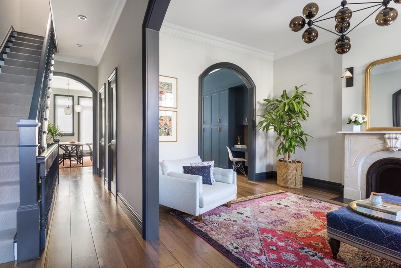 Modern Brownstone Parlor Design with Arched Doorway and Dark Trim