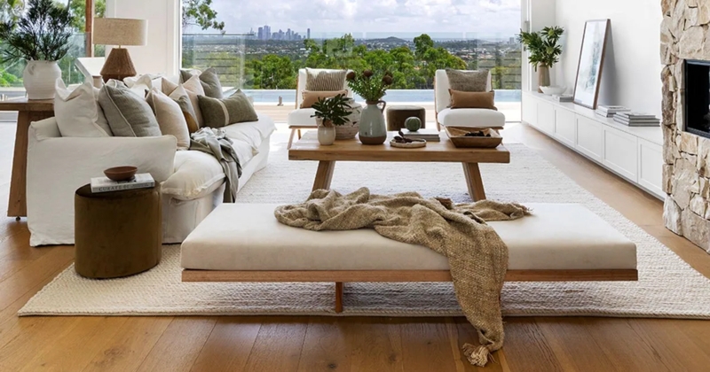 Modern Coastal Living Room with Stone Fireplace and City View Backdrop
