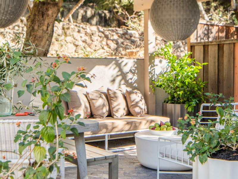 Modern French Country Patio Lounge with Oversized Woven Pendants