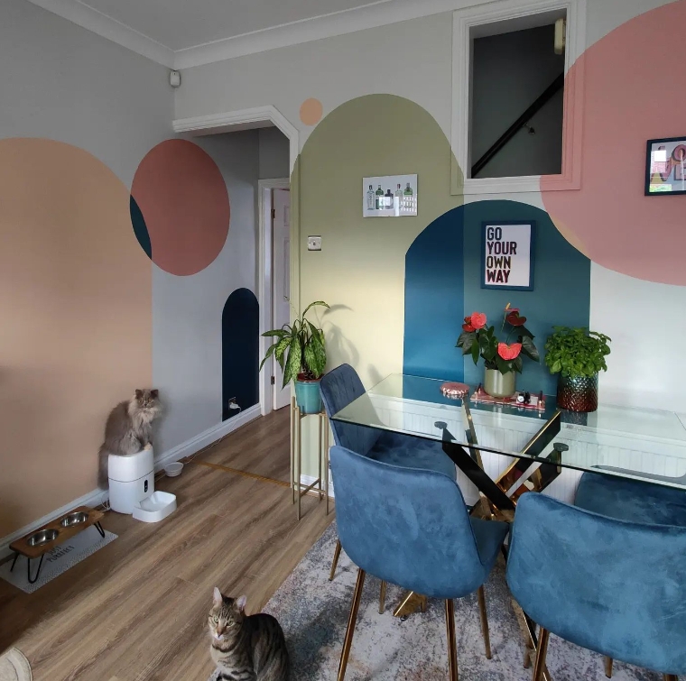 Modern Glam Dining Room featuring Blue Velvet Chairs and Mural