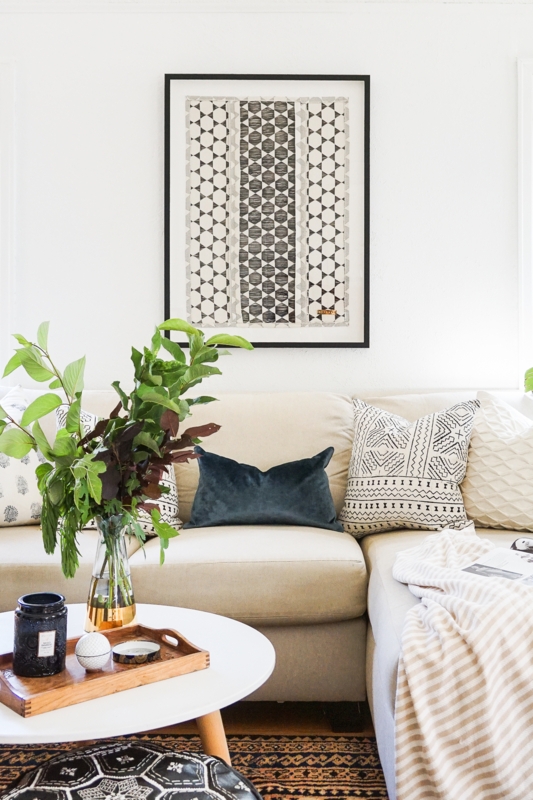 Modern Global Living Room with Geometric Textile Art and Pillows