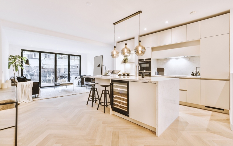 Modern Kitchen Island: Integrated Wine Fridge & Smoked Glass Pendants