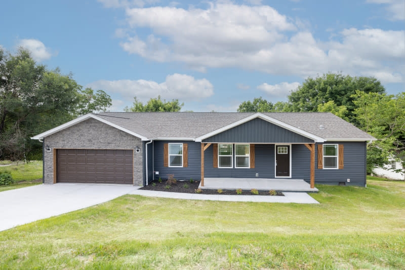 Modern Manufactured Home with Dark Blue Siding and Stone Veneer Gable