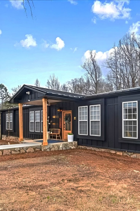 Modern Mobile Home with Charcoal Siding and Natural Wood Posts