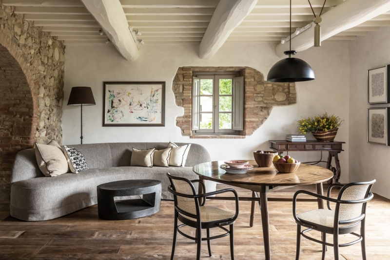 Modern Open Plan Room: Exposed Stone Archway & Curved Sofa