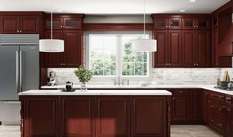 Modernized Cherry Wood Kitchen Cabinets with White Quartz and Drum Pendants
