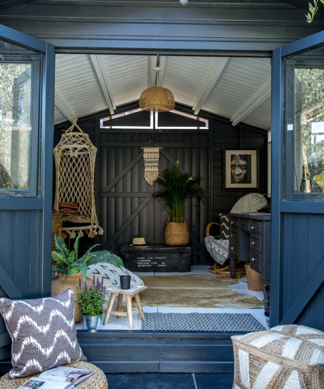 Moody Bohemian Garden Room: Black Interior Walls & Macrame Seating