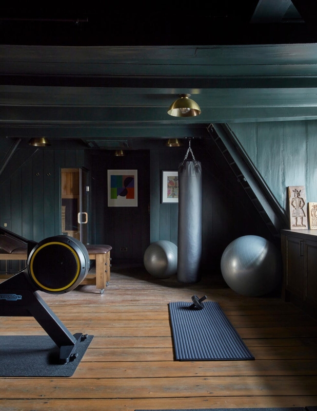 Moody Home Gym With Dark Green Paneling And Sauna