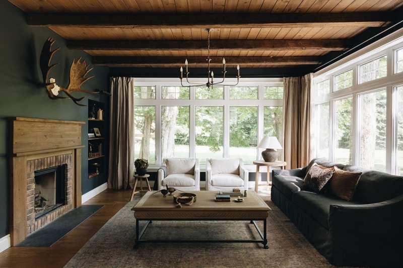 Moody Rustic Living Room with Dark Teal Walls & Antler Wall Decor