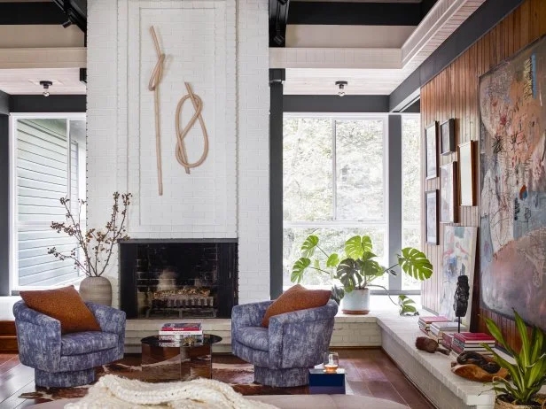 Mottled Blue Swivel Chairs in a Lounge with Vertical Wood Paneling