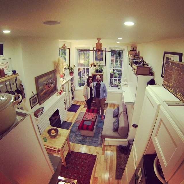 Narrow Studio Apartment with White Brick Fireplace and Eclectic Vibe