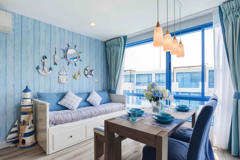 Nautical Dining Nook with Blue Plank Wallpaper and Lighthouse Decor