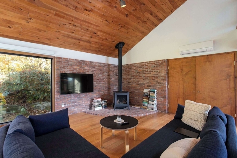 Navy Sectional Sofa in Cabin Living Room with Exposed Brick Walls