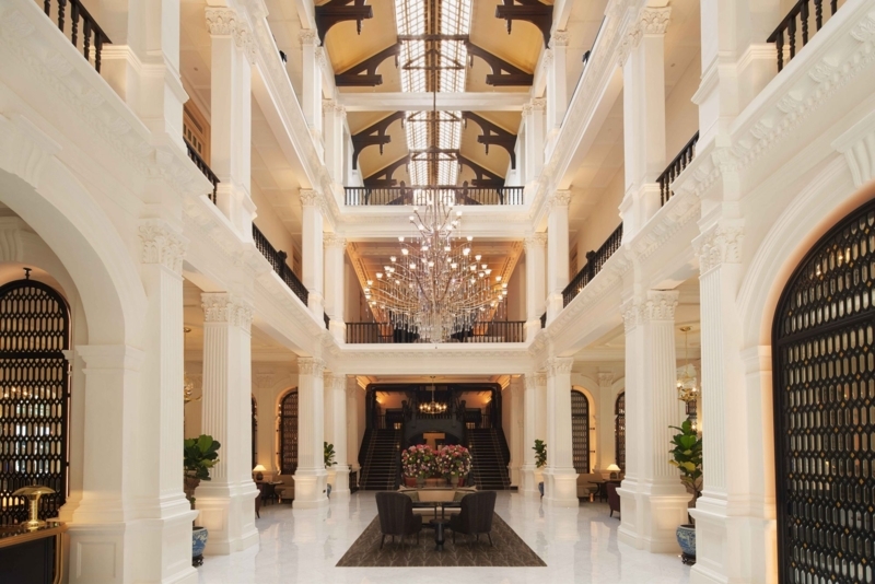 Neoclassical Atrium: White Columns, Tiered Balconies, Massive Chandelier