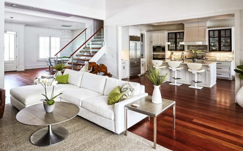 Open Concept Flow: Minimalist Glass Railing Staircase & White Sectional
