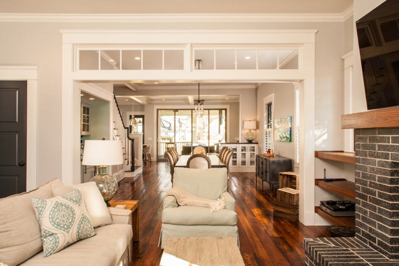 Open Concept Living Room with Black Brick Fireplace & Transom Windows