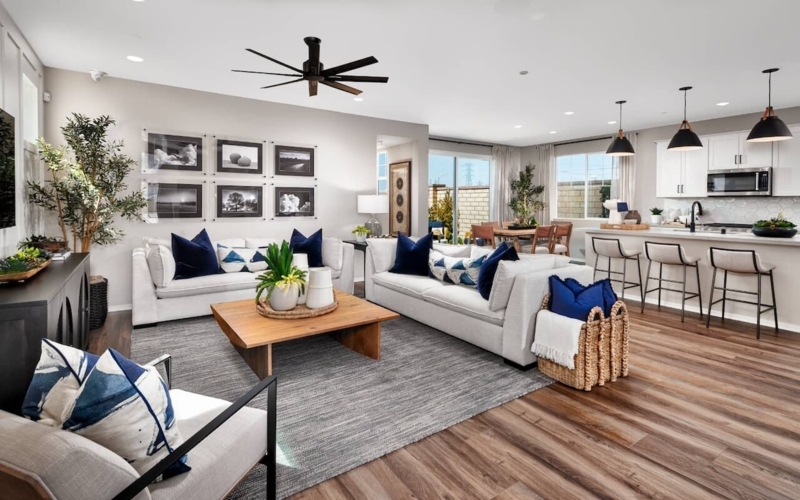 Open Floor Plan Layout: Navy Blue Living Room Accents & Black Fixtures
