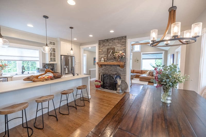Open Floor Plan Living Area with Stone Fireplace & Kitchen Island