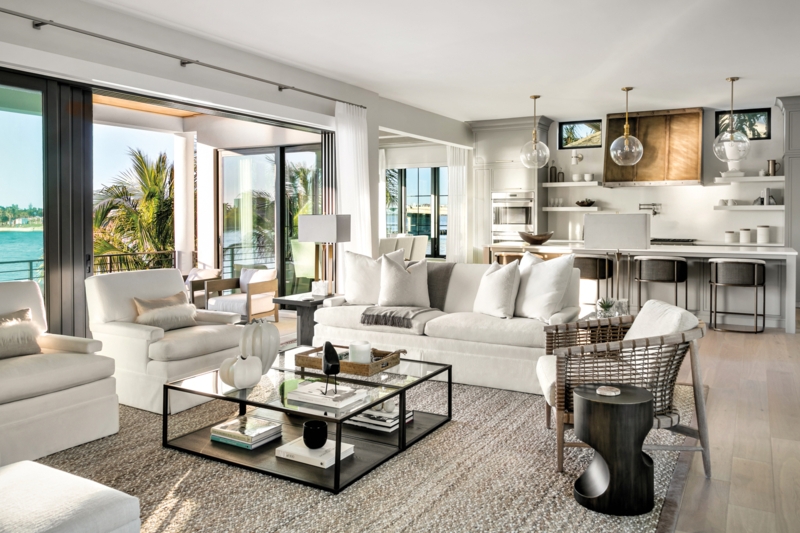 Open Plan Coastal Living Room with Sliding Glass Doors and Woven Chair