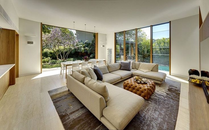 Open Plan Living Area: Indoor-Outdoor Connection & Tufted Ottoman