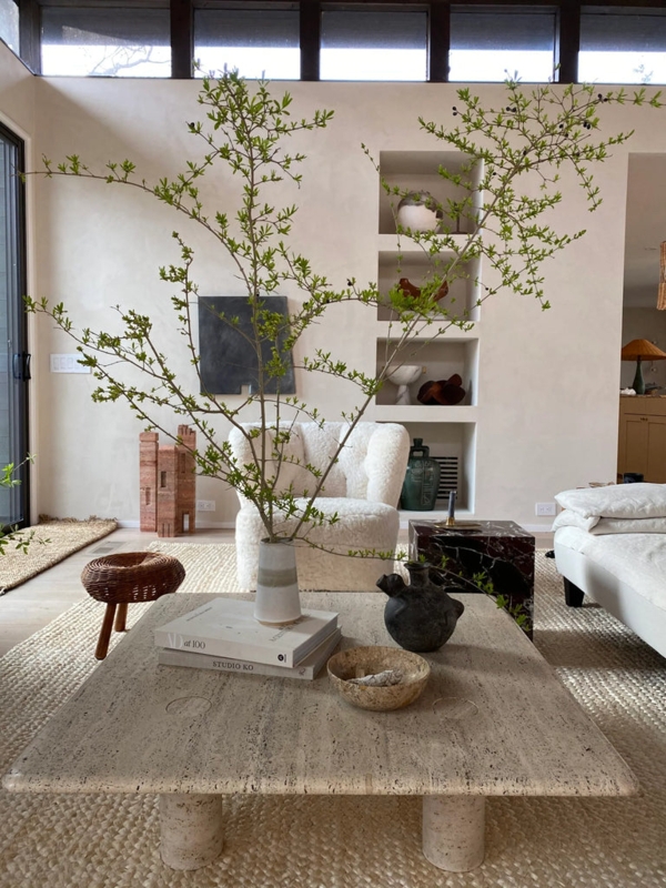 Organic Modern Living Room: Stone Block Coffee Table & Fuzzy Armchair.