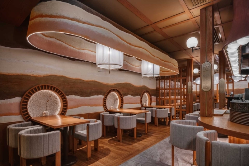 Organic Modern Restaurant: Layered Clay Wall Design & Circular Niches