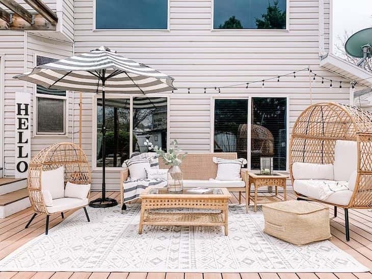 Outdoor Living Set with Teardrop Egg Chairs and Striped Umbrella