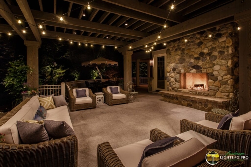 Outdoor Patio with Stone Fireplace, Pergola Roof, and Wicker Seating