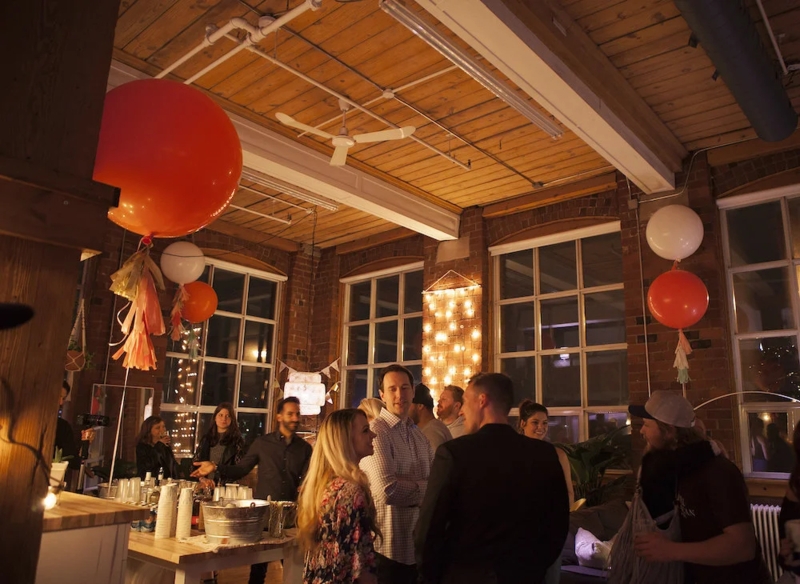 Oversized Balloon Arrangements In An Exposed Wood Ceiling Loft Space