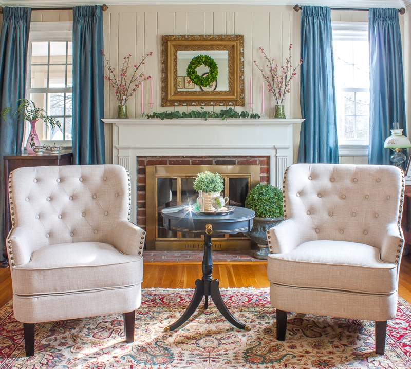 Pair of Beige Tufted Wingback Chairs in Symmetrical Fireplace Layout