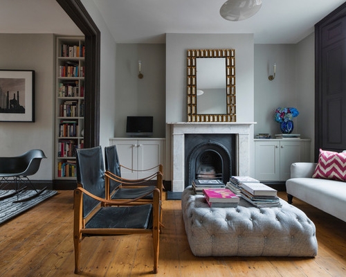 Pair of Black Sling Armchairs with Tufted Ottoman and Fireplace