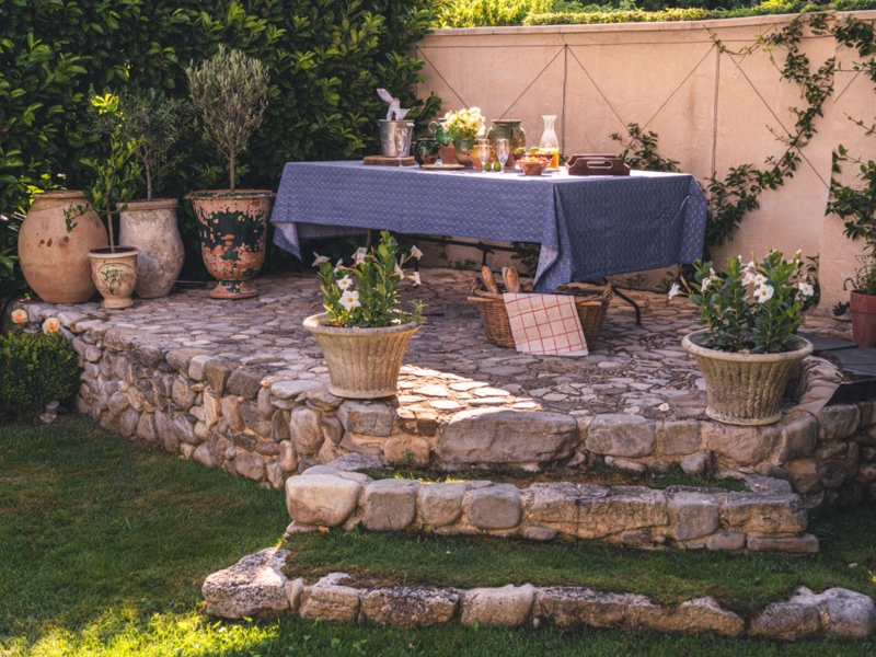 Patio Dining Area On An Elevated Dining Platform With Stone Wall