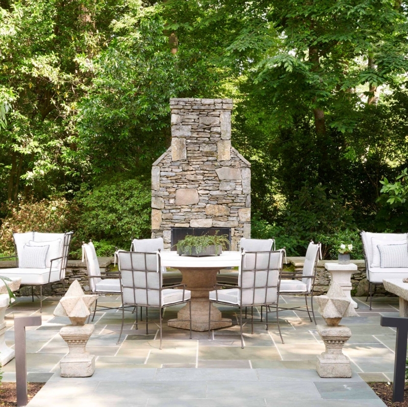Patio Dining Set near Monumental Stone Fireplace in Elegant Garden