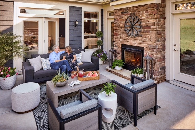 Patio Lounge with Geometric Monochrome Rug and Stacked Stone Fireplace