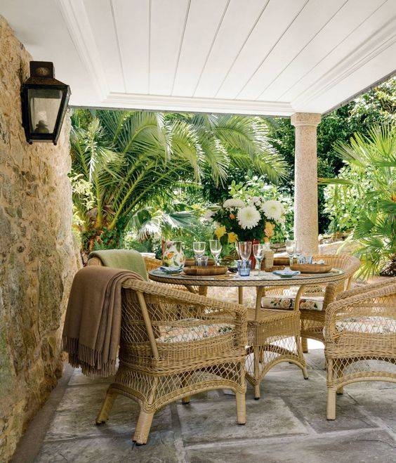 Rattan Cane Outdoor Dining Set with Lattice Weave Detail on Stone Patio