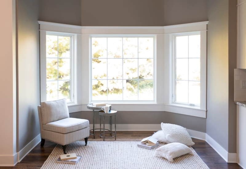 Reading Nook with Minimalist Corner Chair Layout and Nesting Tables.