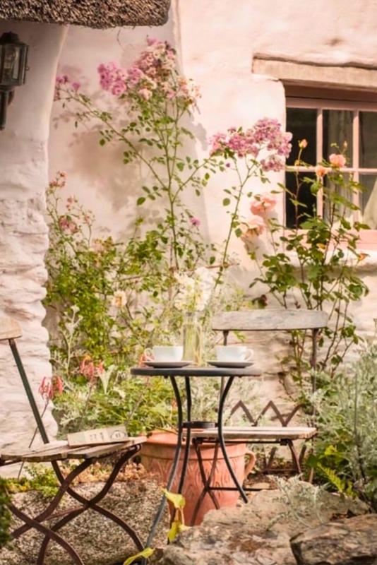 Romantic Bistro Set in Cottage Garden Nook with Thatched Roof