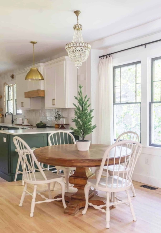 Round Pedestal Dining Table with white spindle back chairs.