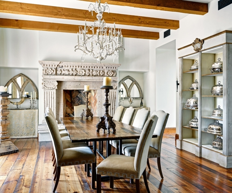Rustic Dining Room featuring exposed ceiling beams and stone fireplace.