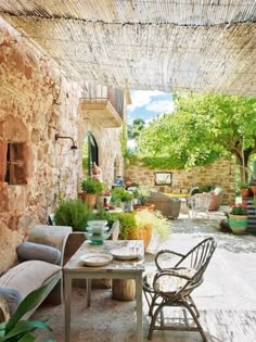 Rustic Mediterranean Patio Dining under Reed Shade Canopy