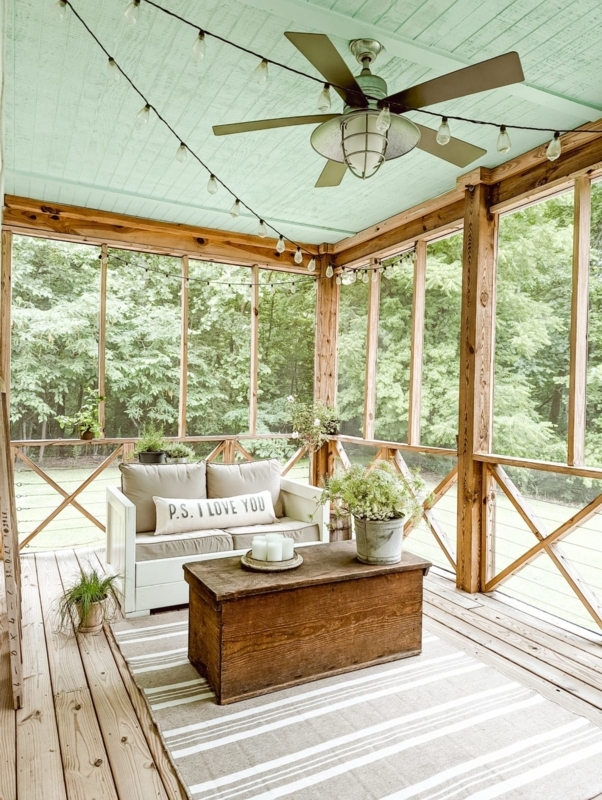 Rustic Porch with Mint Green Ceiling, Trunk Coffee Table & String Lights.