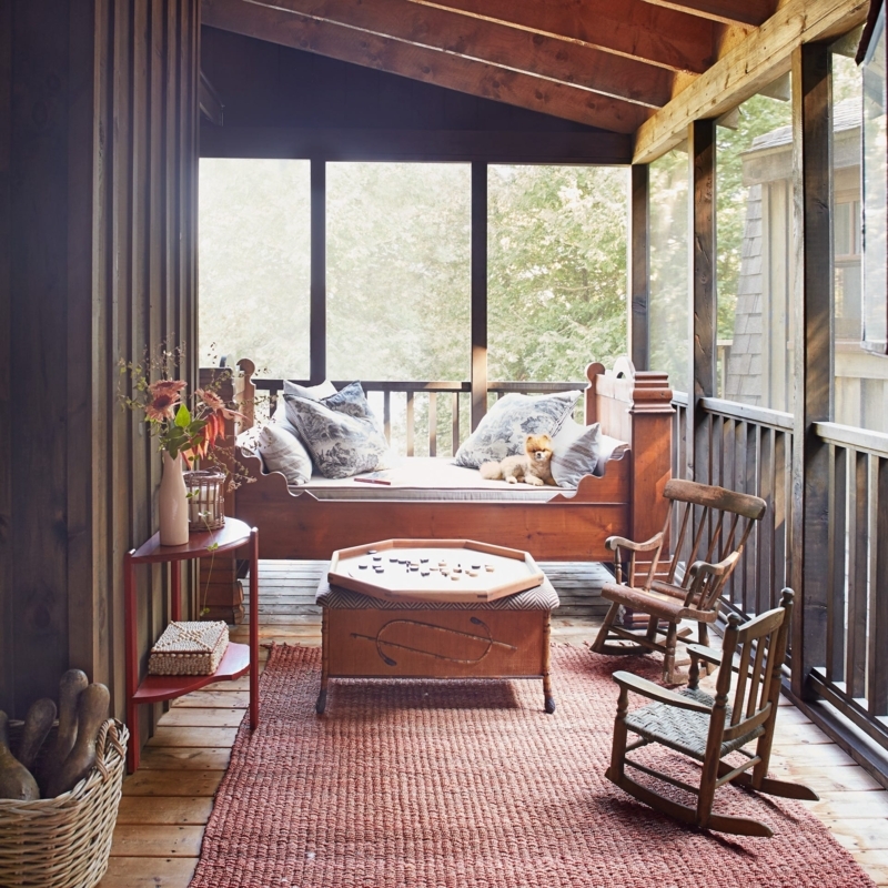 Rustic Porch with Terracotta Jute Rug, Daybed & Sloped Beamed Ceiling.