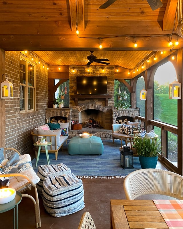 Rustic Stone Fireplace Porch with Wood Plank Ceiling & Teal Ottoman.
