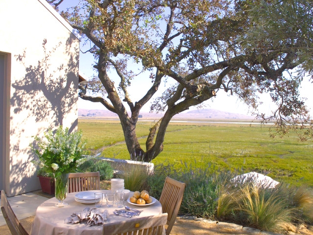 Rustic Wood Outdoor Dining Set on Patio with Scenic Marsh View