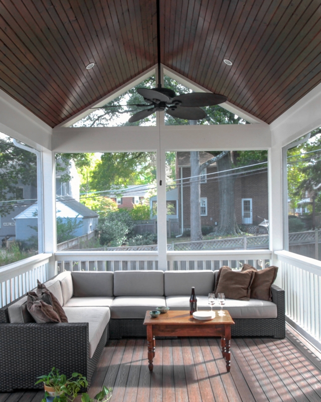 Screened Porch: Vaulted Wood Ceiling, Woven Sectional, Leaf Blade Fan.